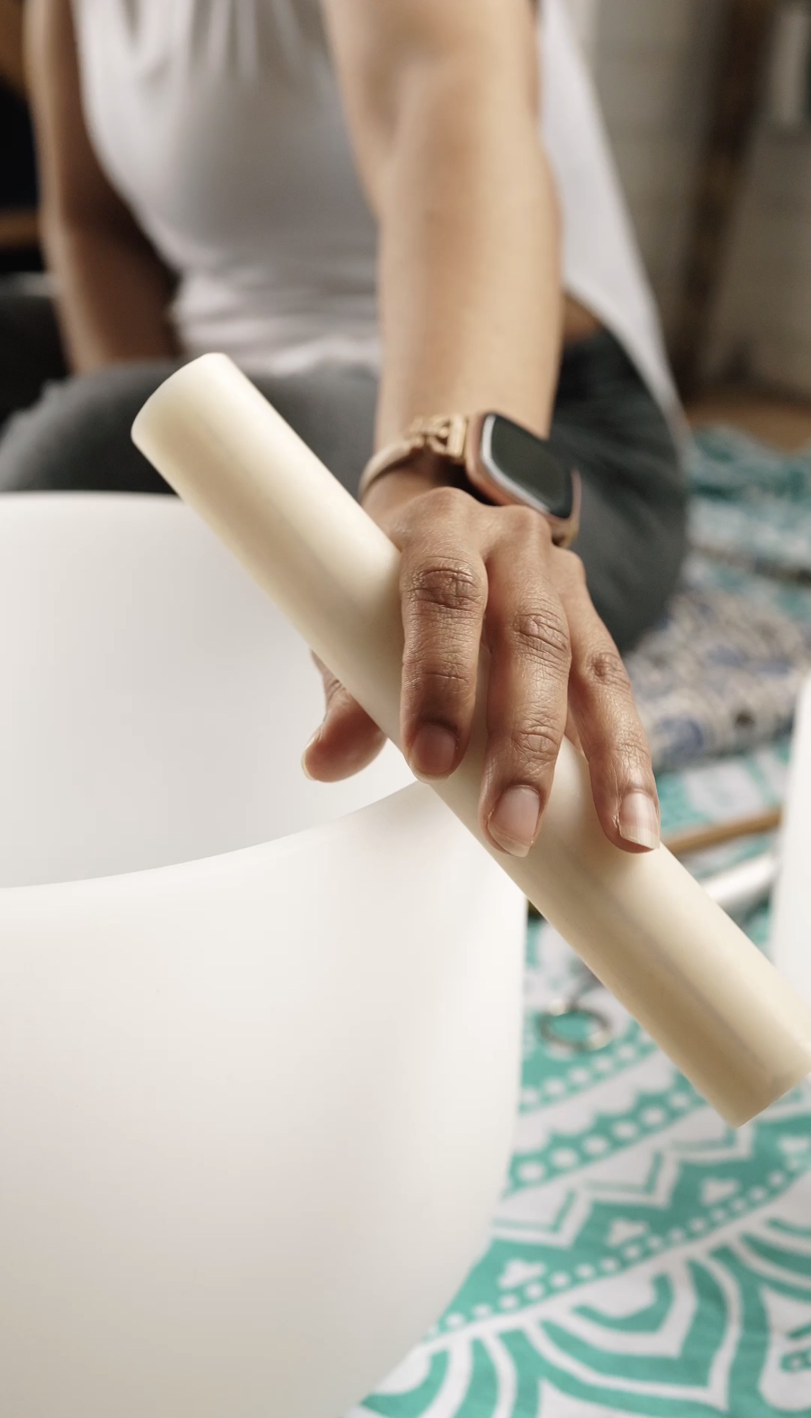 A hand resting on a singing bowl